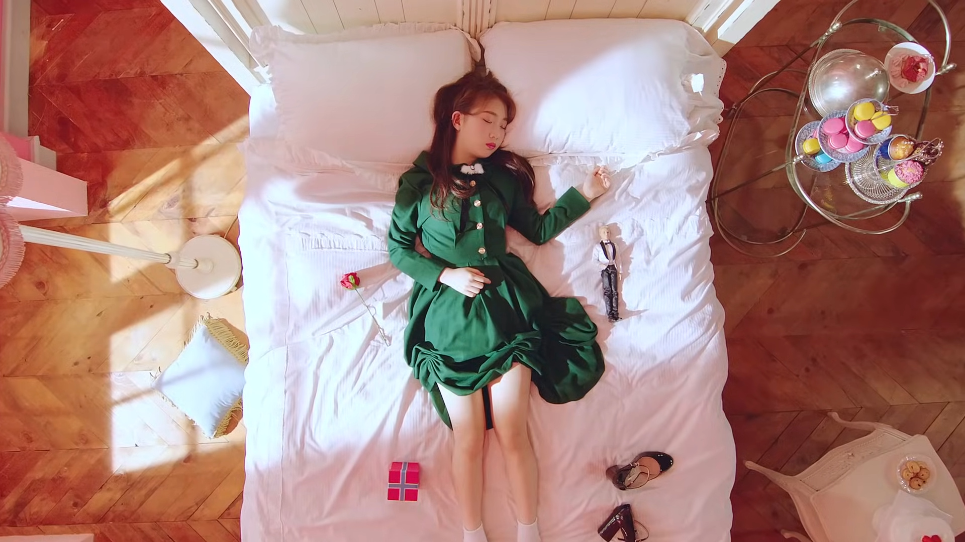 Yeojin sleeping on a bed surrounded by objects.
